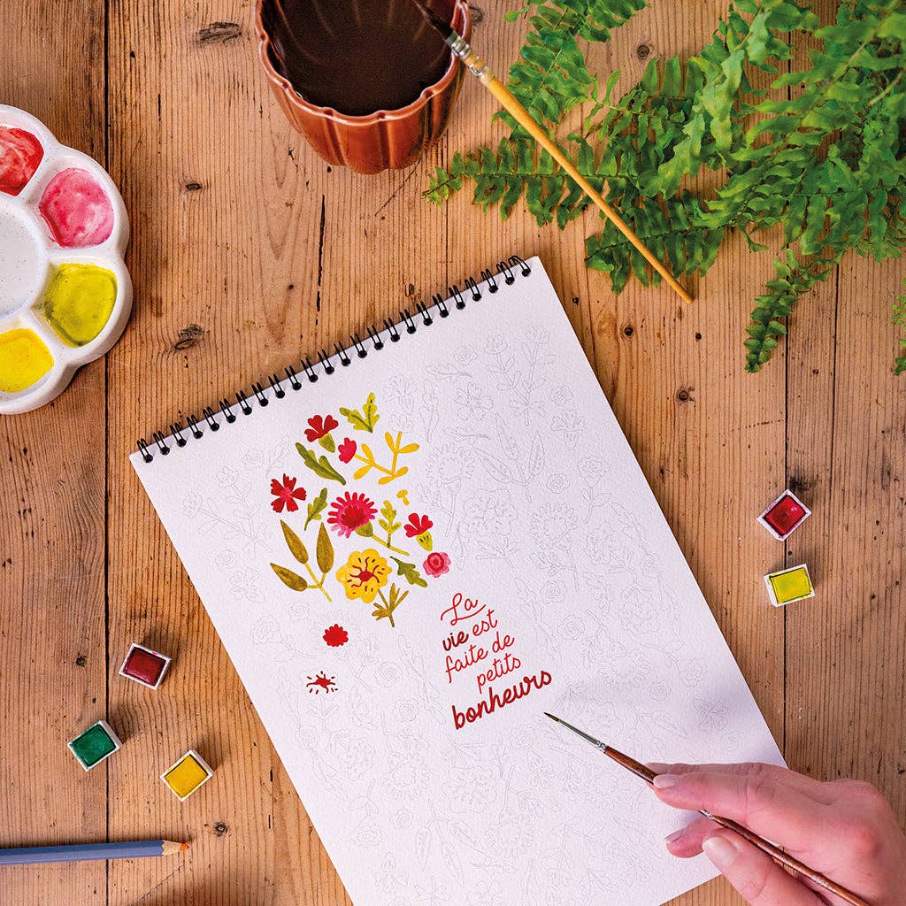 Carnet de coloriage créatif A4 ouvert. Illustration fleurie et phrase inspirante prêtes à être coloriées